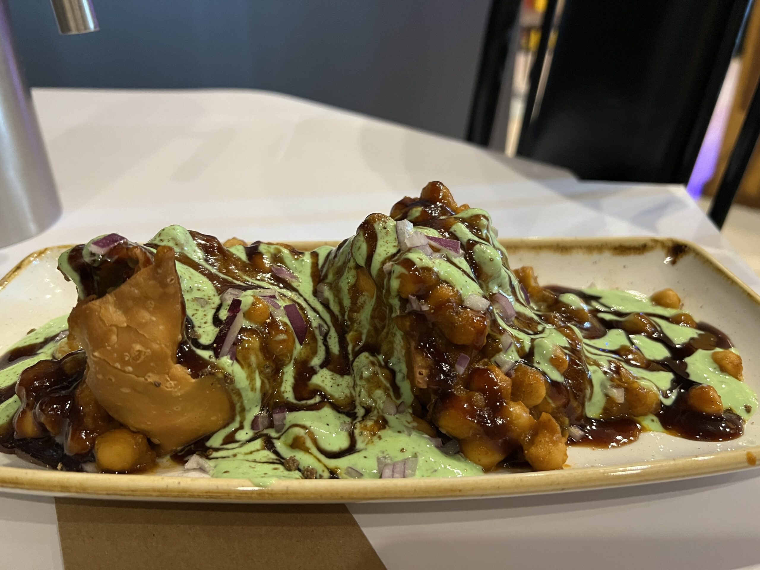 Samosa Chat @ Indian Experience Restaurant (Tuggerah). Crispy flaky, pastry served with chick peas, chillies, yoghurt, tamarind chutney and mint chutney & coriander. Samosa Chat @ Indian Experience Restaurant (Tuggerah). Crispy flaky, pastry served with chick peas, chillies, yoghurt, tamarind chutney and mint chutney & coriander.